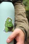 close up of Cyclops sitting on rock Sticker on green bottle